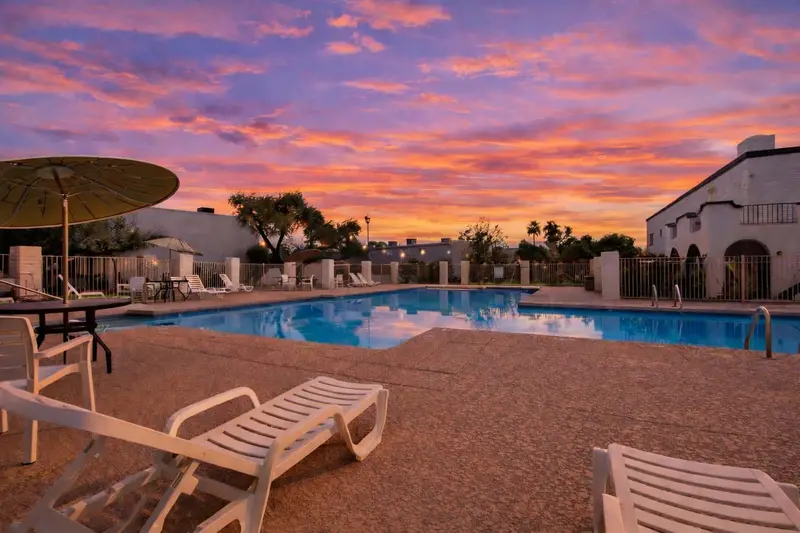 Casa Granada East community pool with lounge chairs and a cabana, a short walk from Hideaway