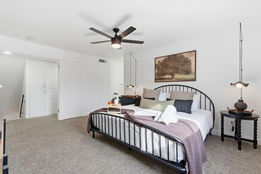 King bed with layered bedding in the primary bedroom at Hideaway
