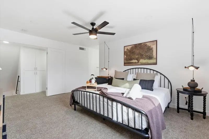 King bed with layered bedding in the primary bedroom at Hideaway